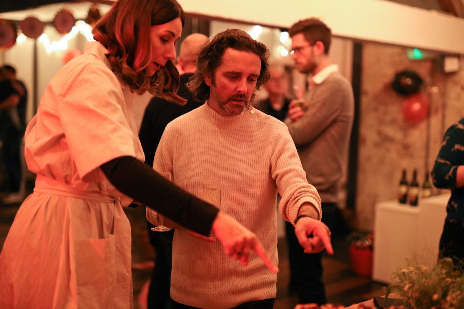 Two guests pointing at the canapés